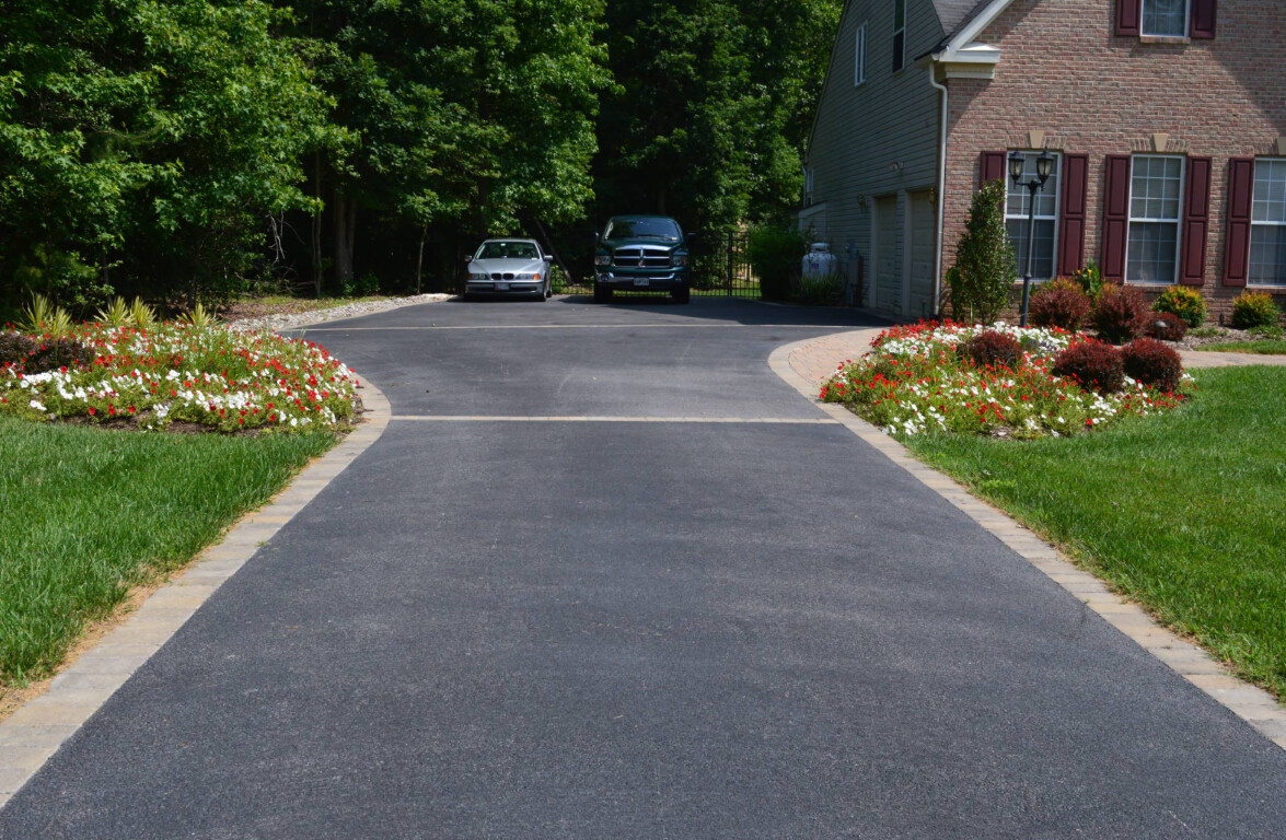 Professional concrete driveway installation with decorative curved borders in Torrington, CT