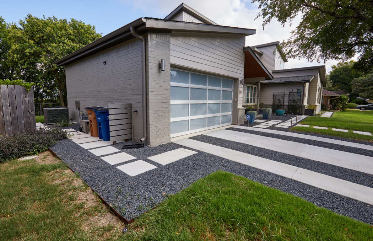 Modern stamped concrete driveway with decorative paver pattern